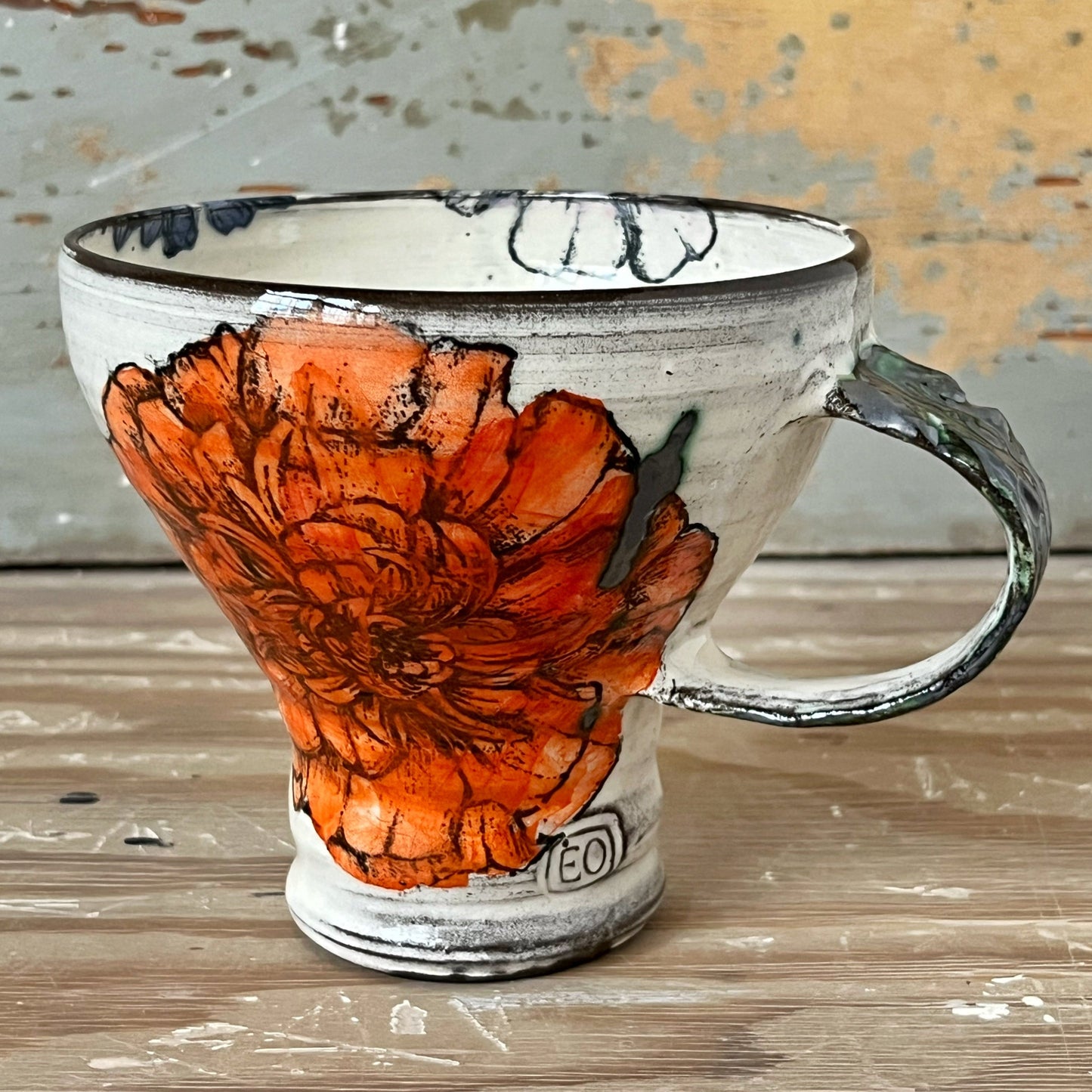 Handmade ceramic mug with marigold flower