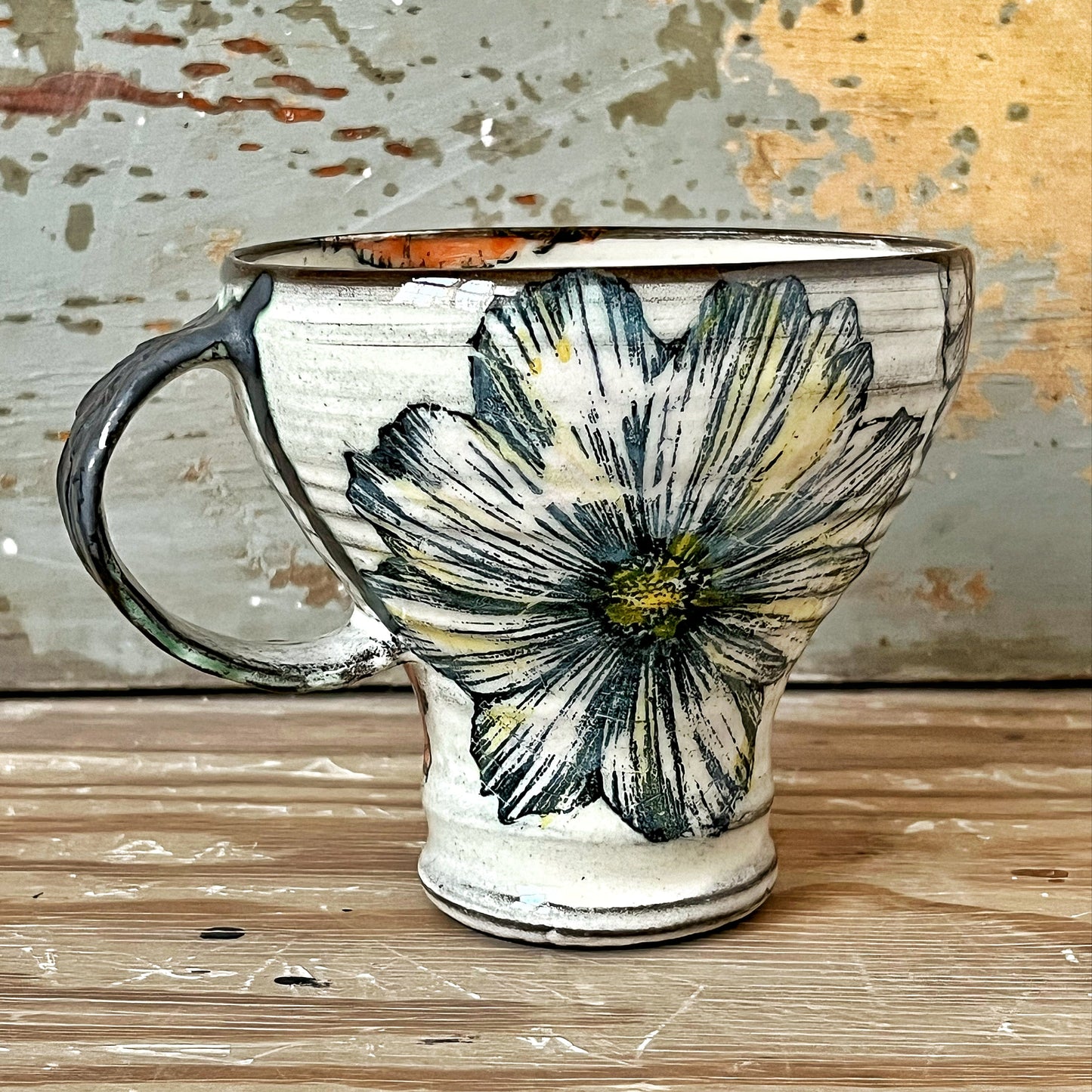 Handmade ceramic mug with flower motif