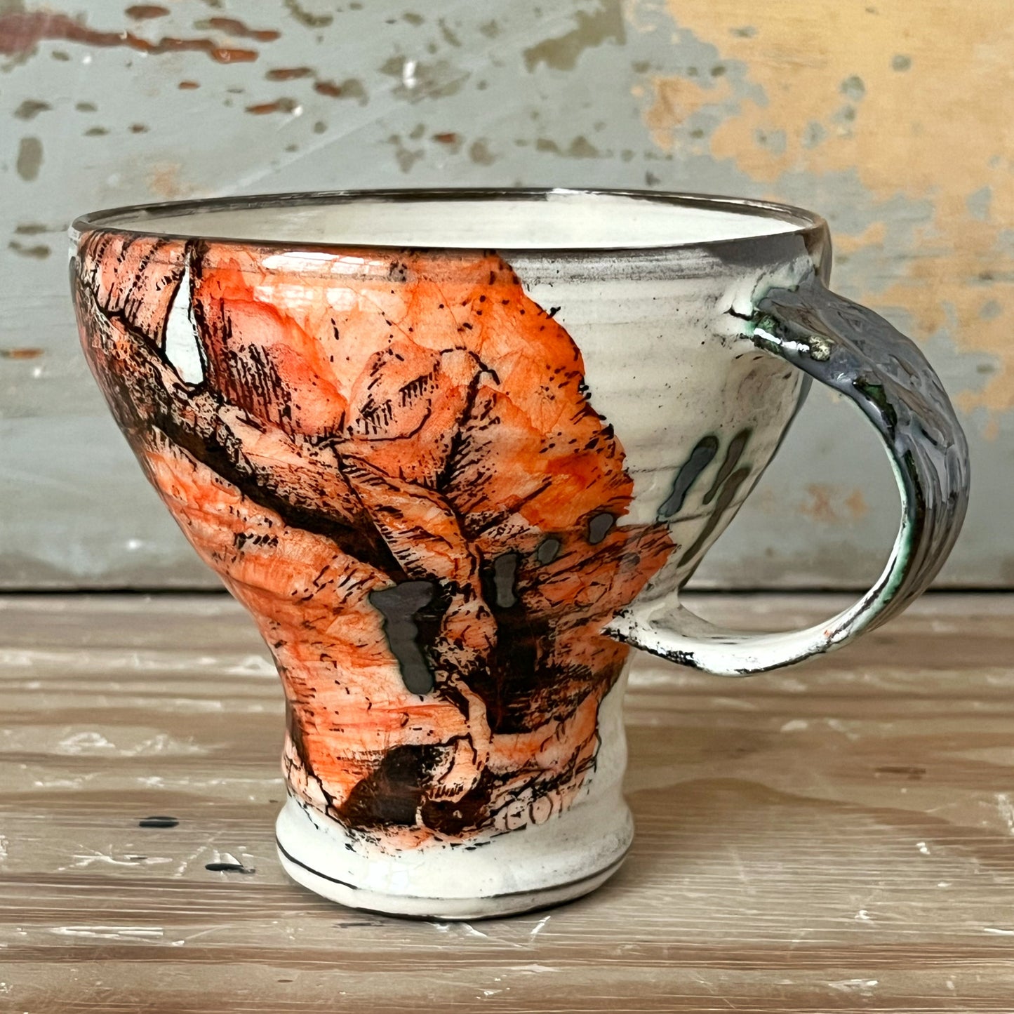 Handmade ceramic mug with poppy flower