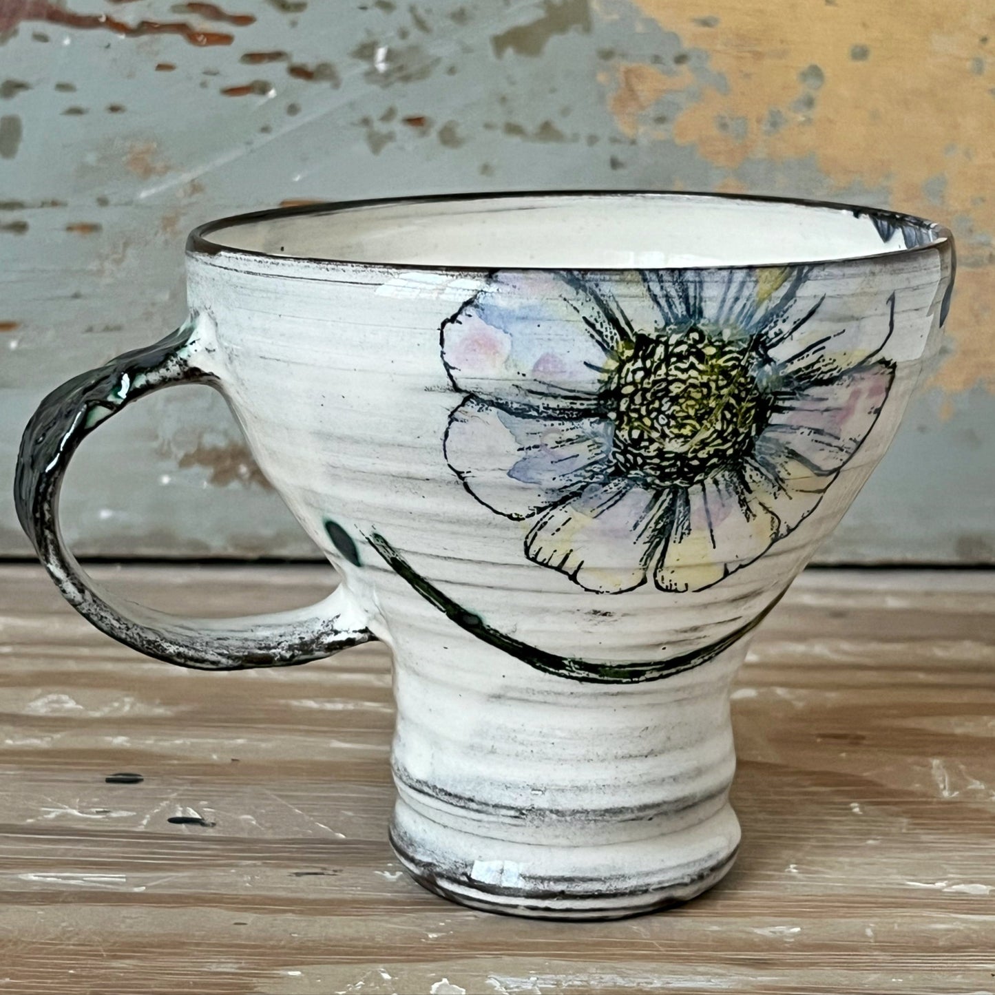 Handmade ceramic mug with purple flower