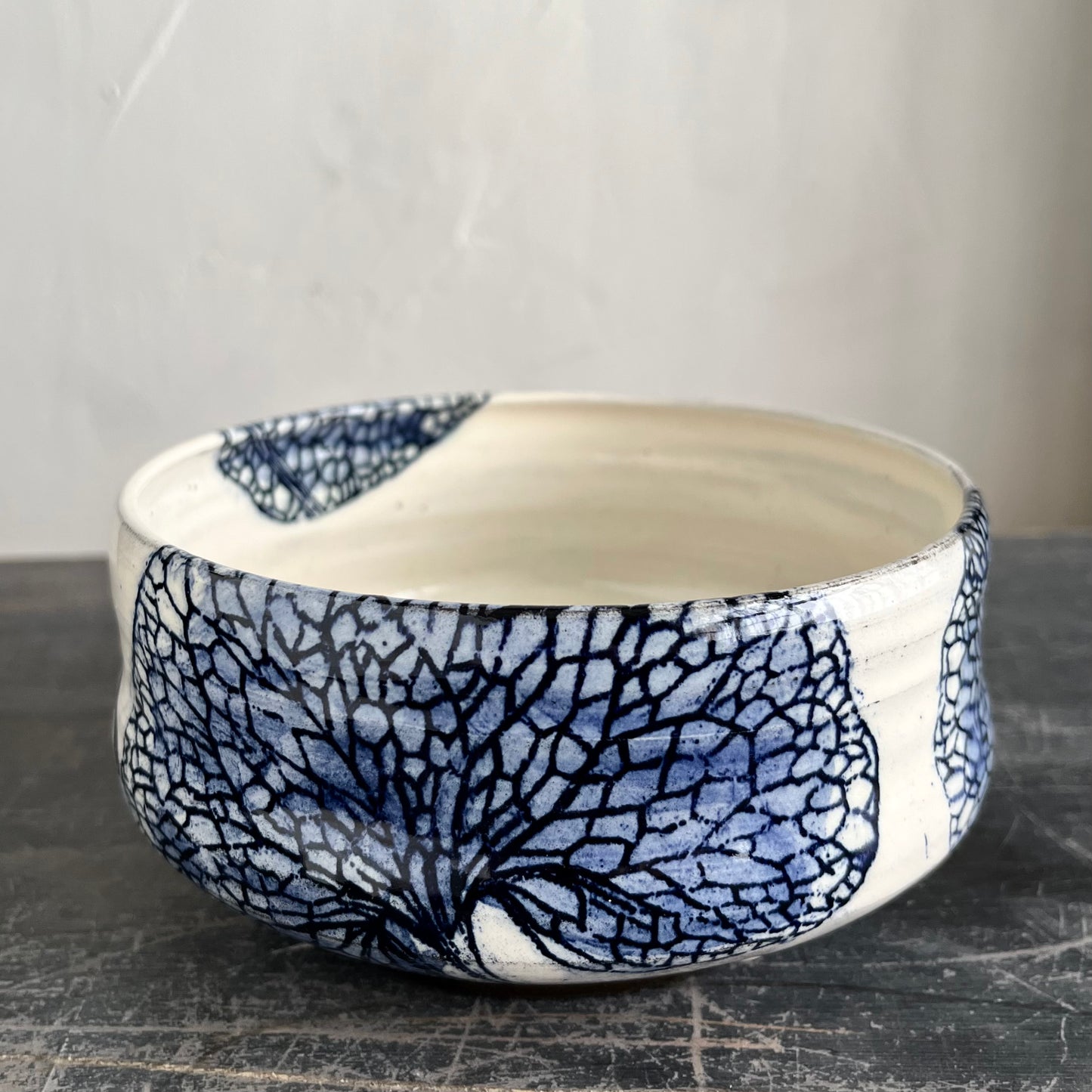 Handmade wheel thrown bowl, white with blue leaf decorations