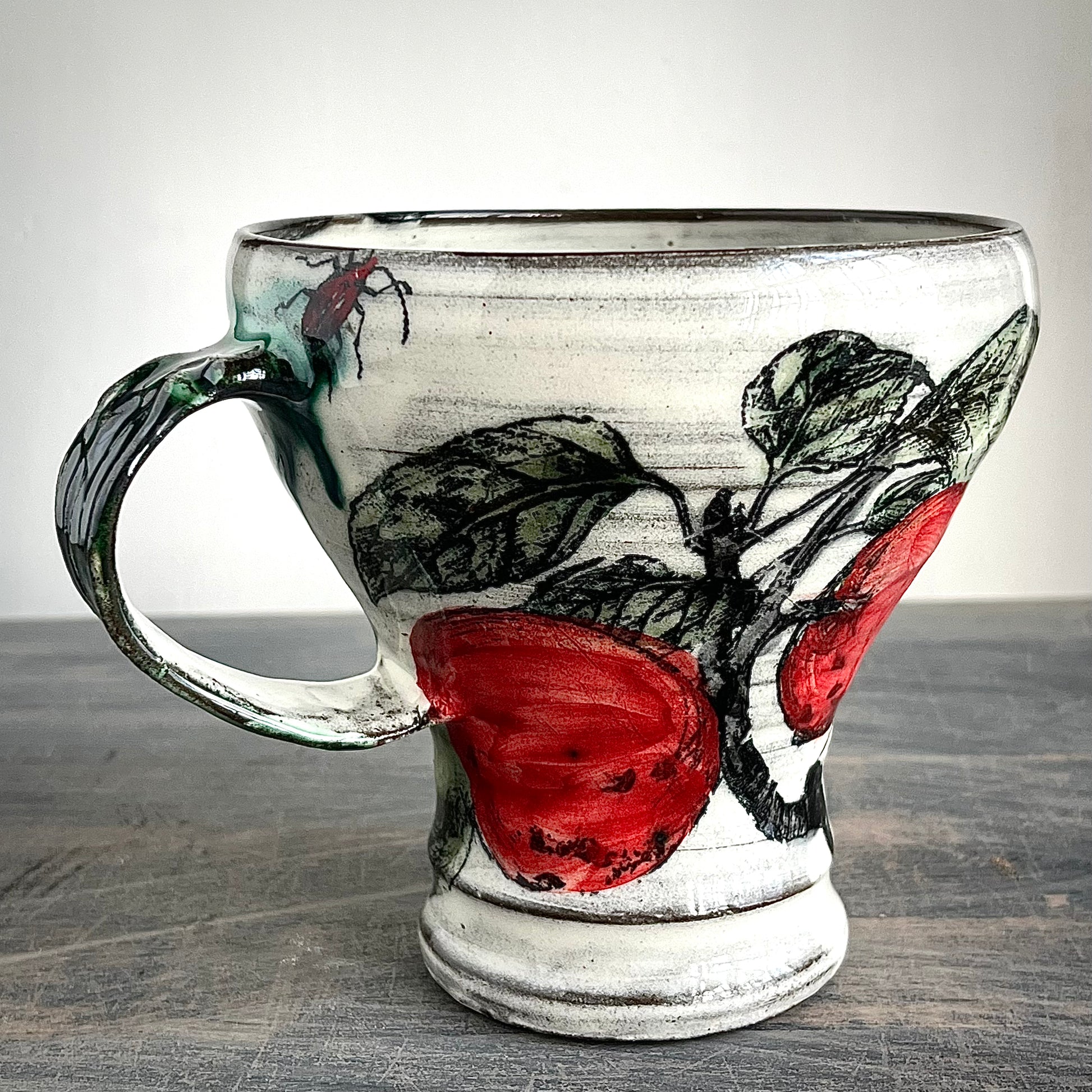 handmade ceramic mug decorated with apple, pears and insects