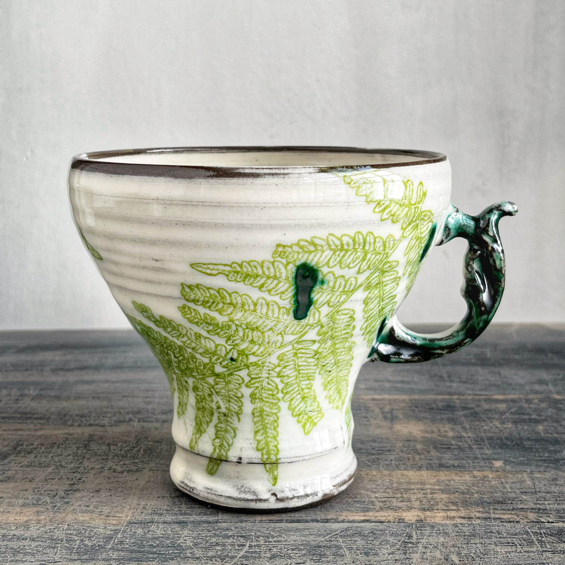 Handmade ceramic mug, white with green motif 