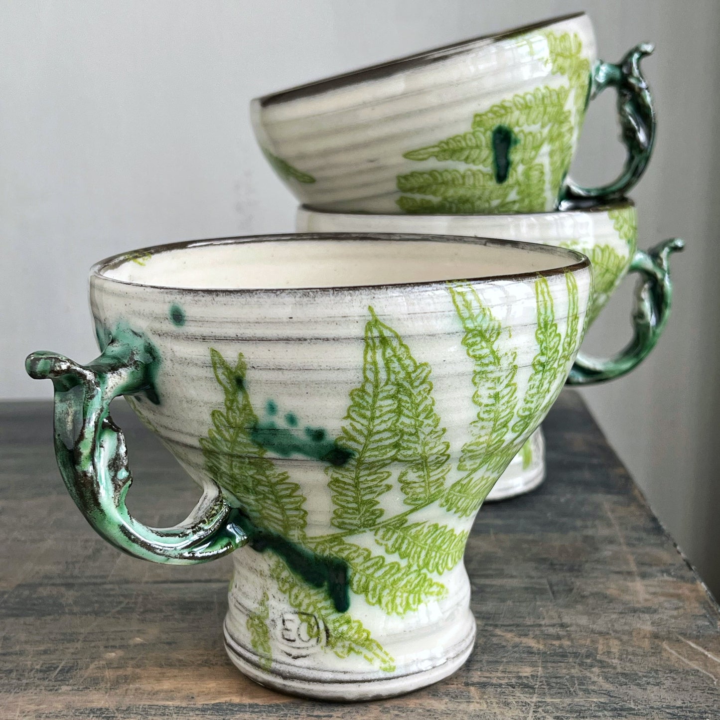 handmade ceramic mugs, white with green fern motif 