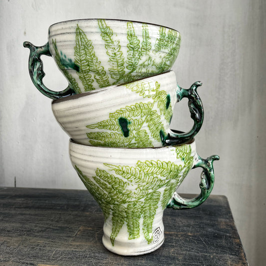 Handmade ceramic mugs with green fern motif 
