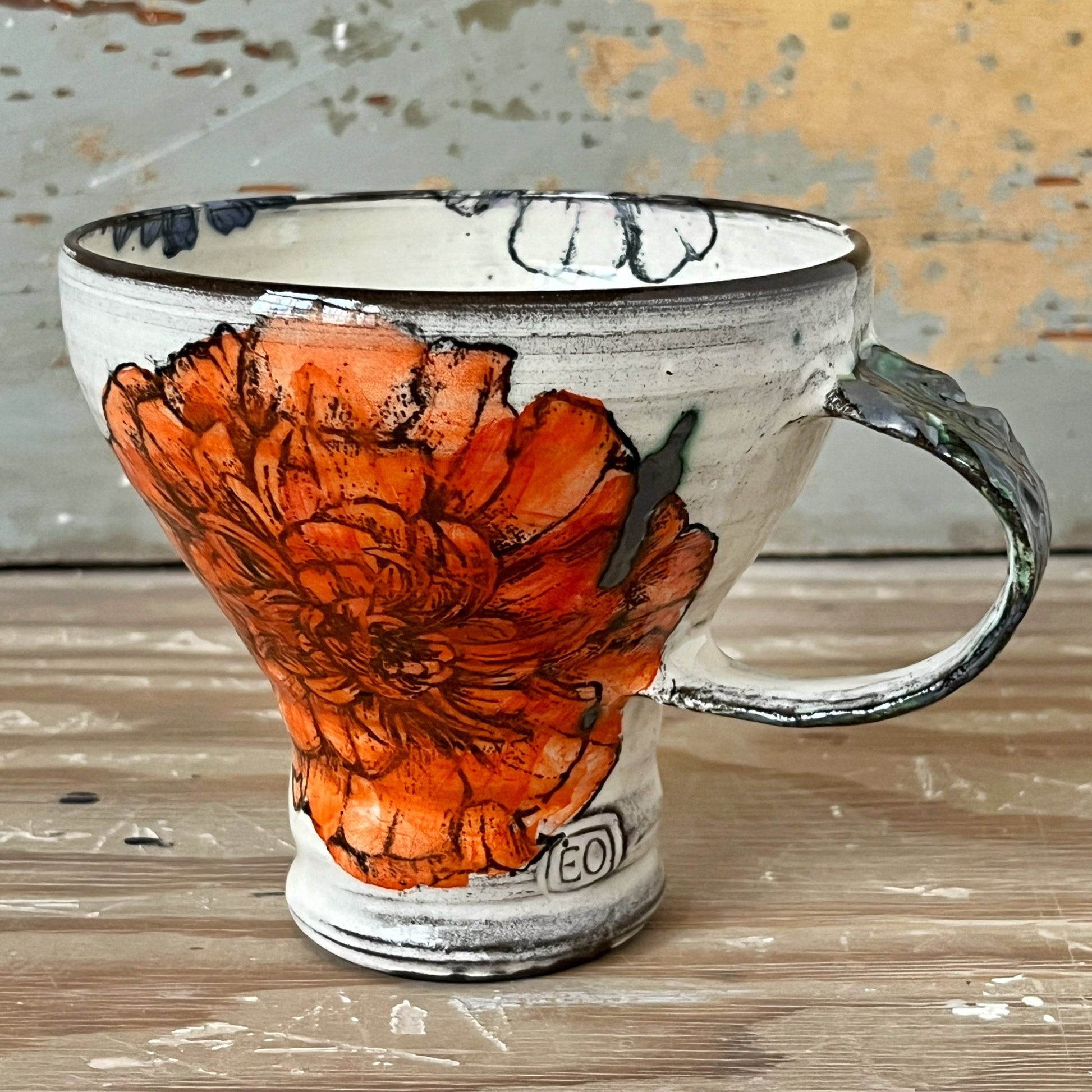 Handmade ceramic mug with marigold flower 