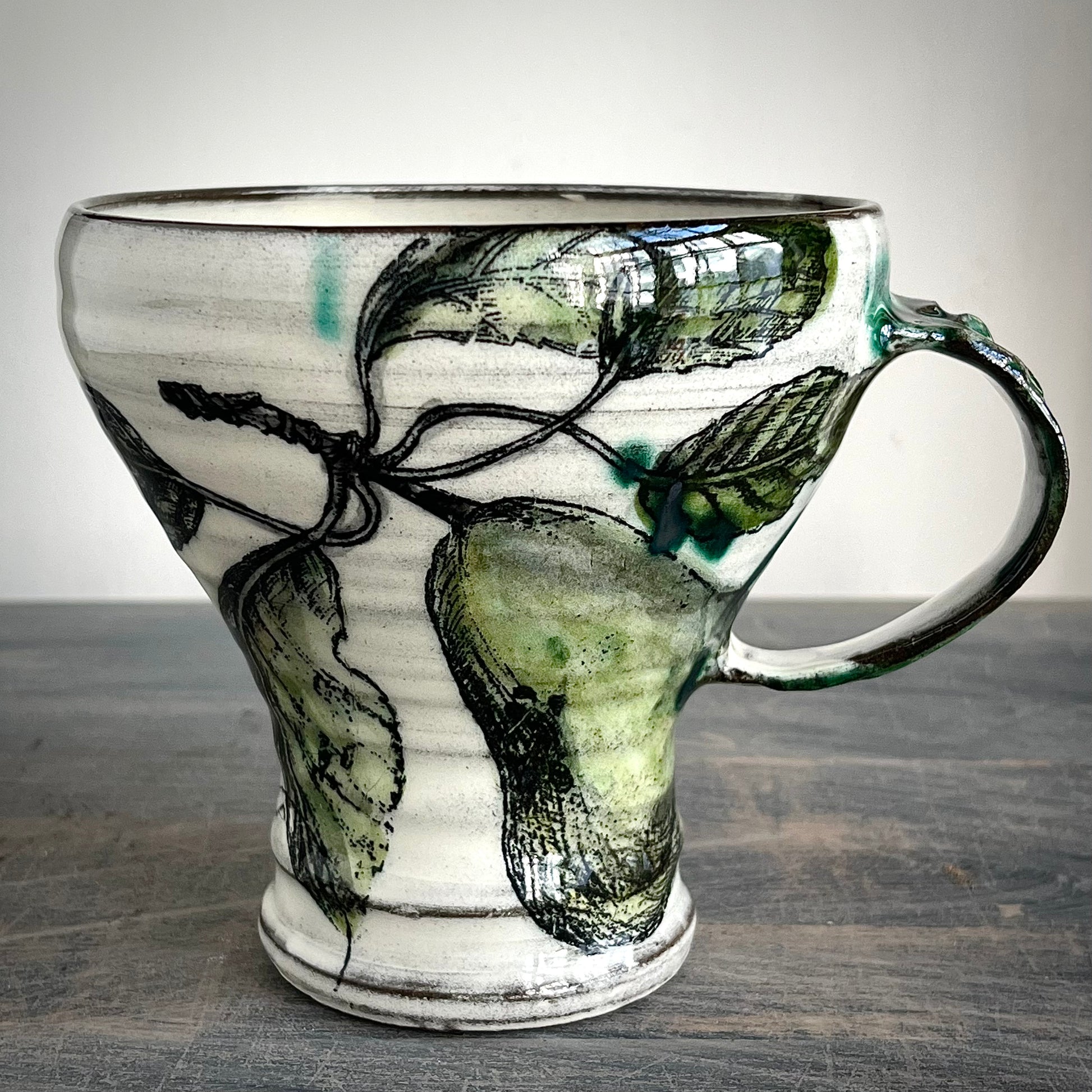 handmade ceramic mug decorated with pear and insects