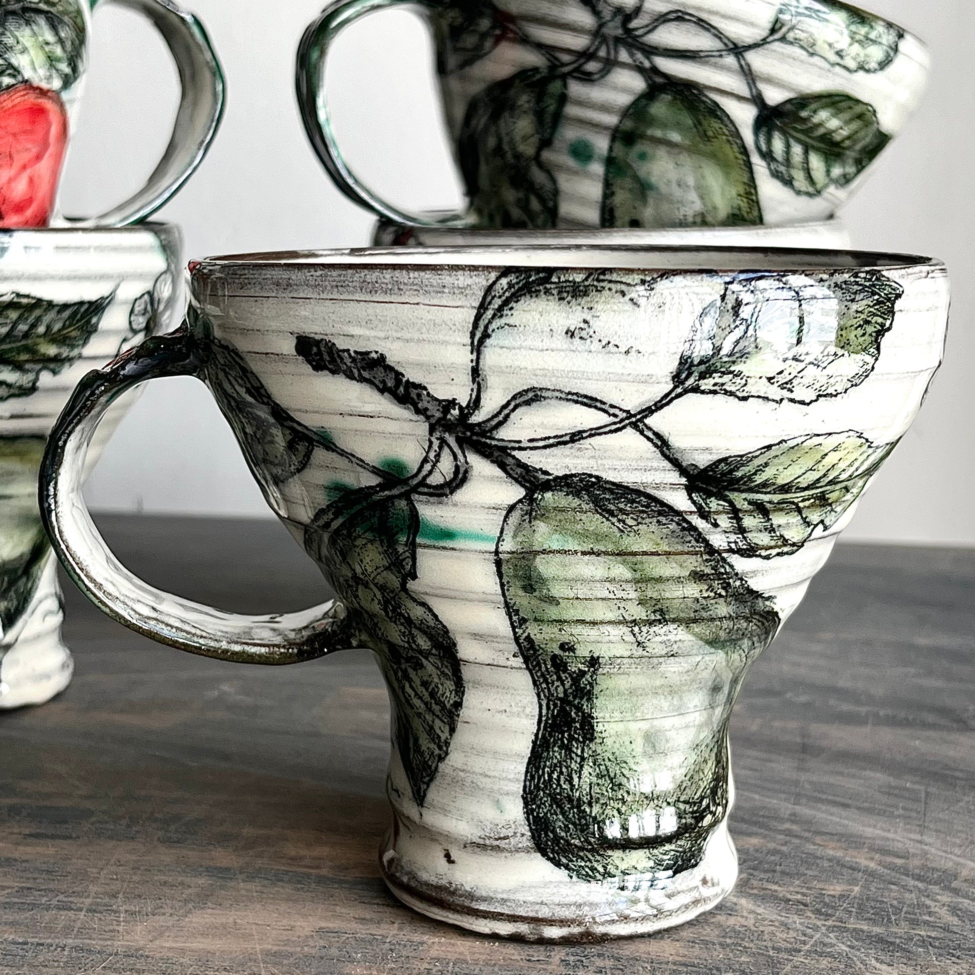 wheel thrown ceramic mugs, decorated with apples and pears