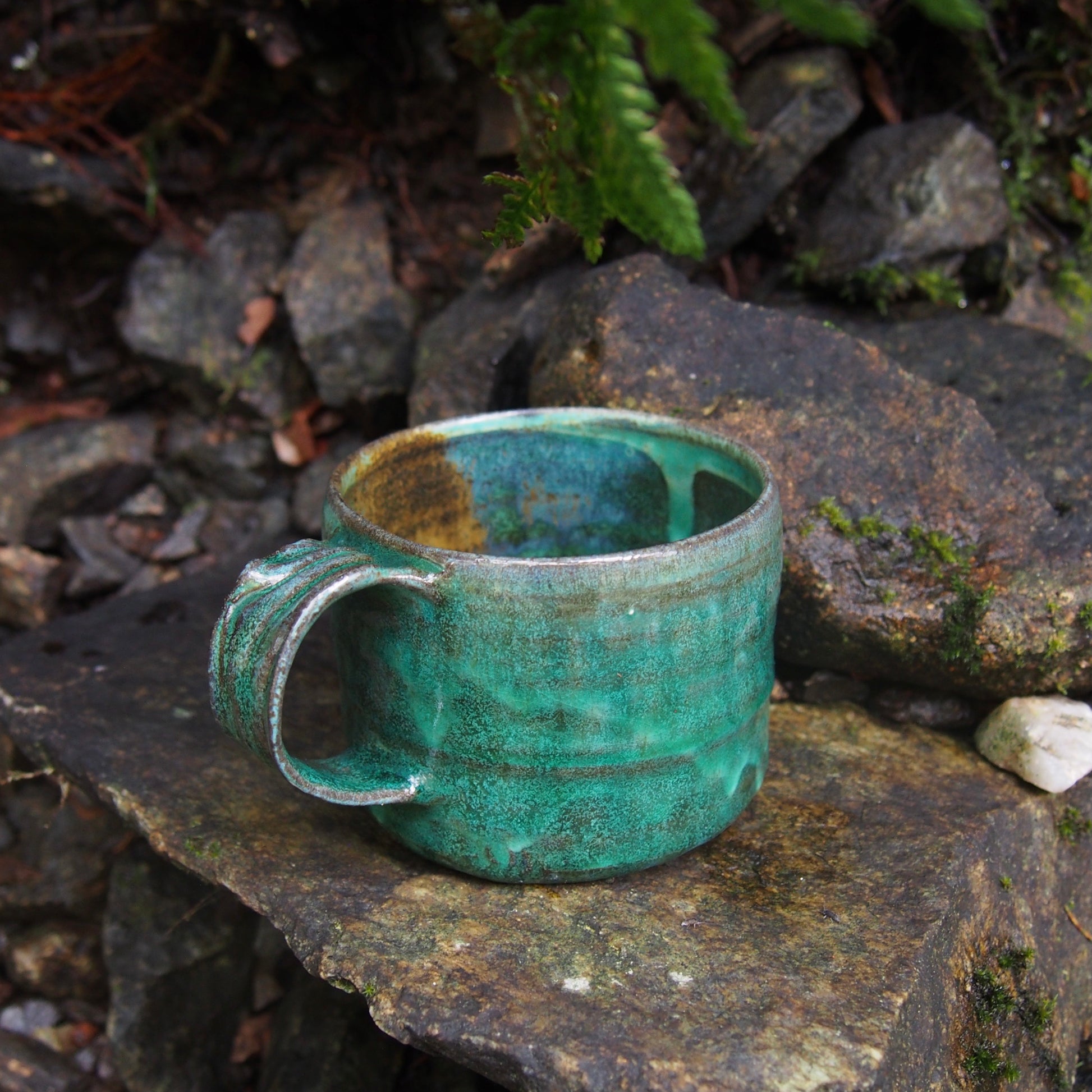 Handmade ceramic cup in nature