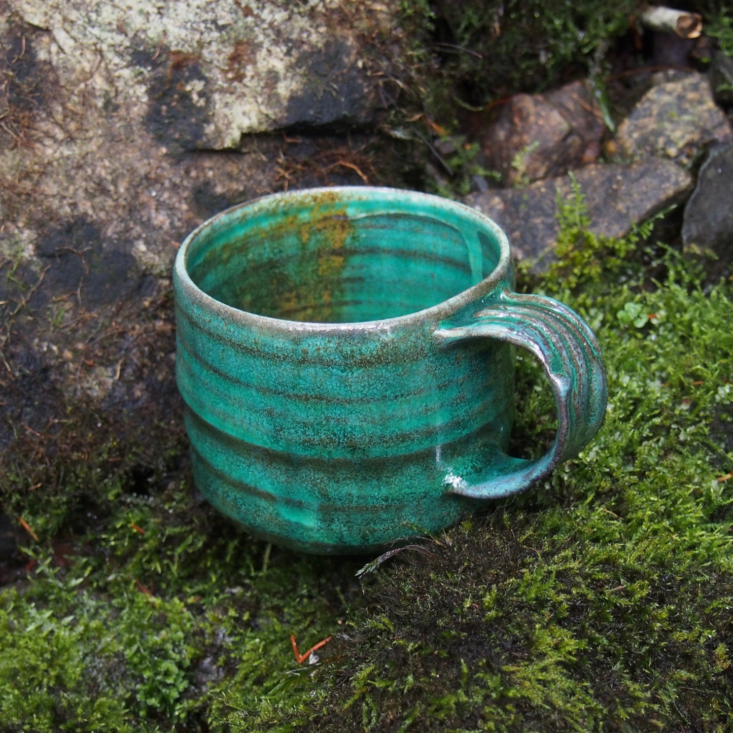 Handmade ceramic cup in nature