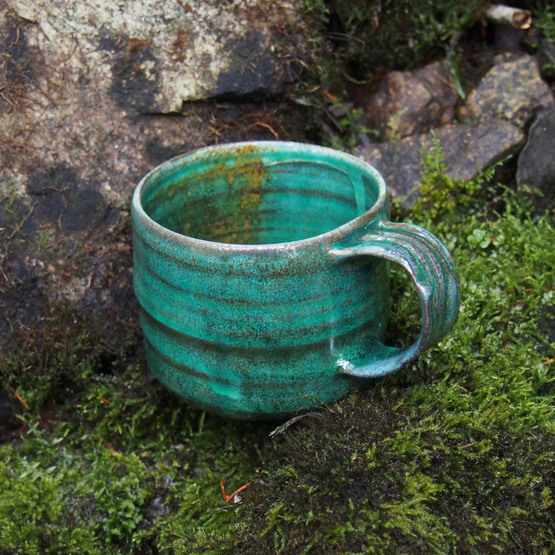 Handmade ceramic cup in nature